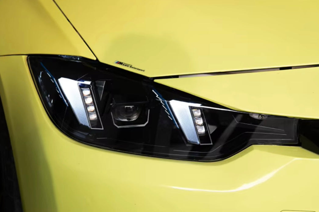 Close-up of a car headlight on a yellow vehicle