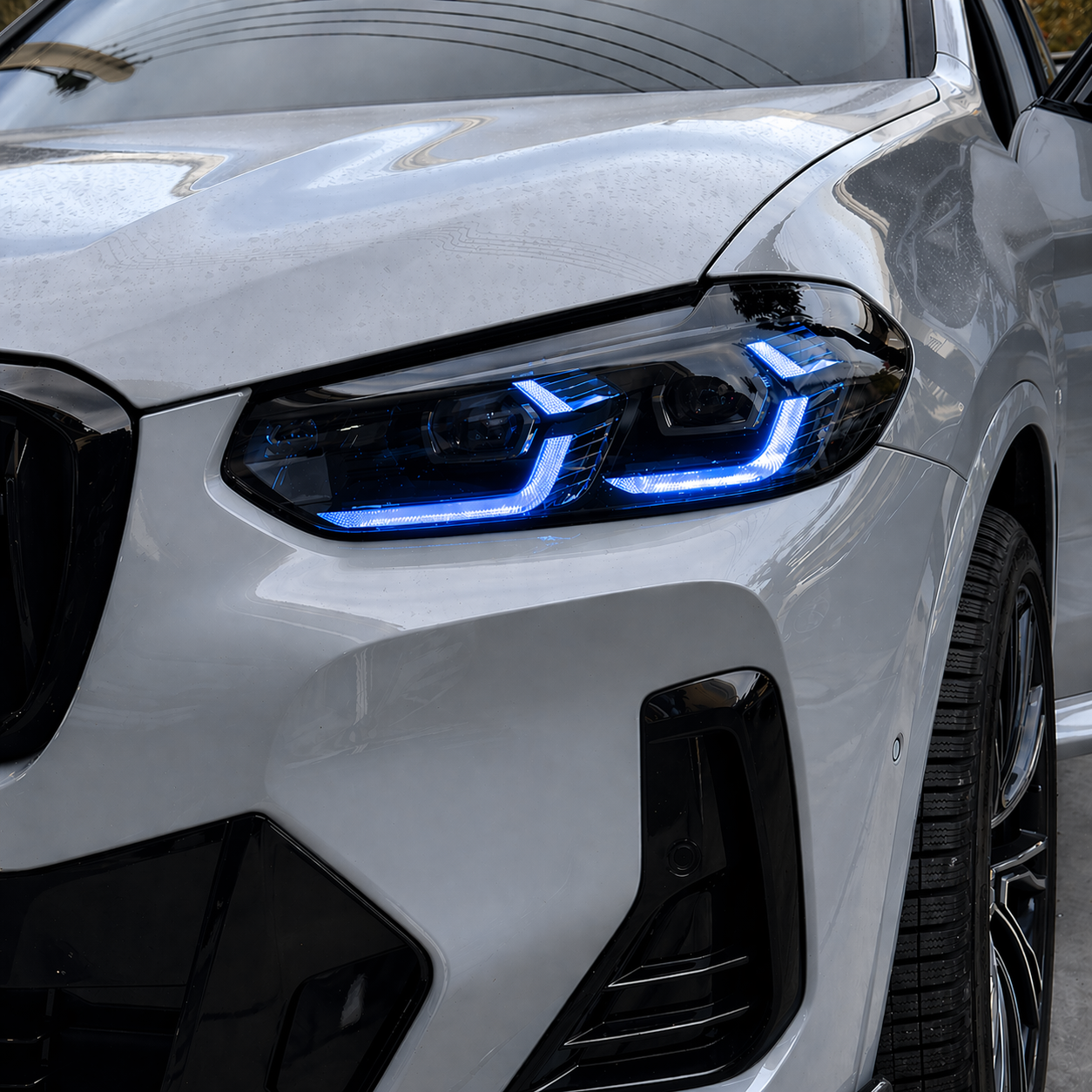 Close-up of a BMW X3/X4 with blue DRL.