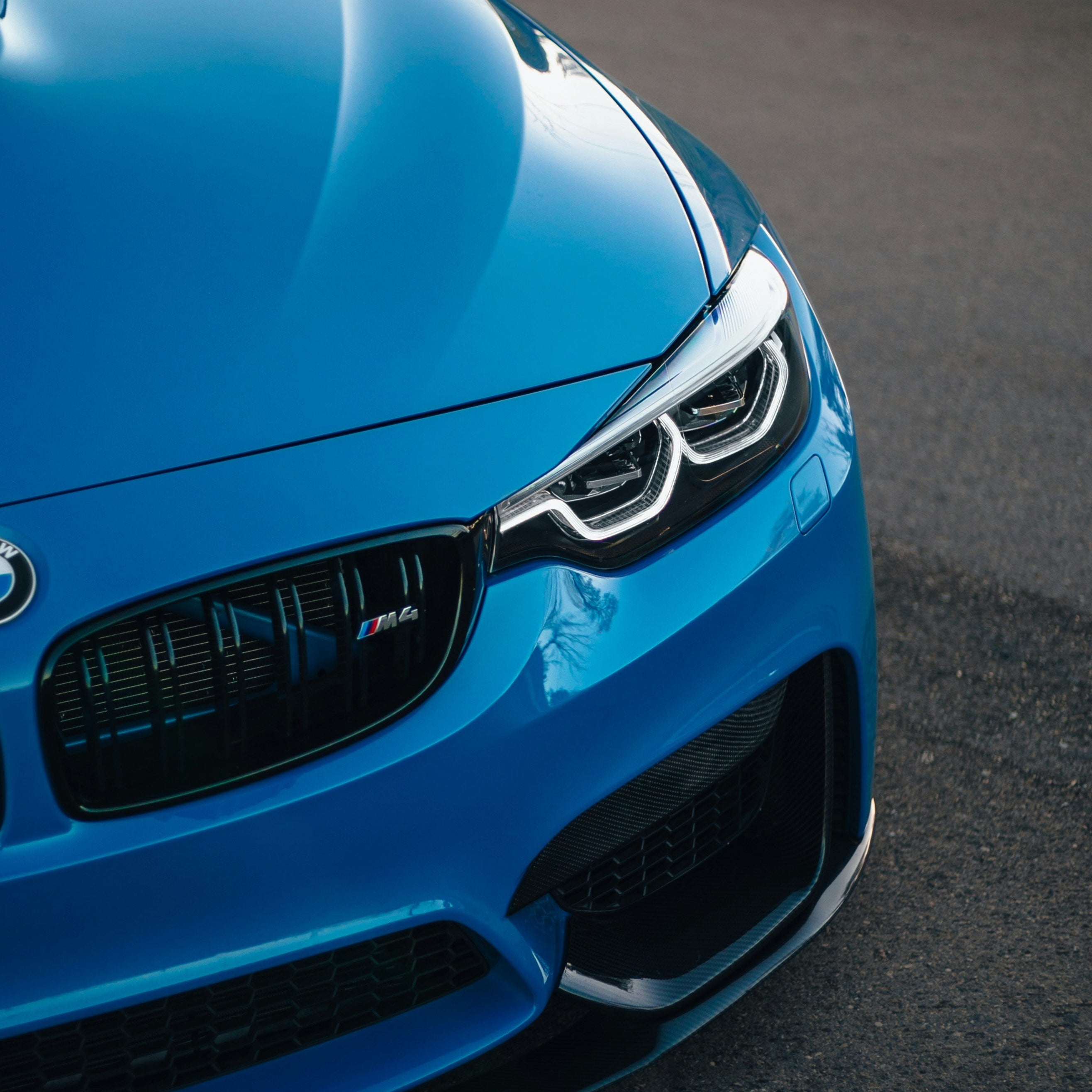 Close-up of a blue BMW car on a road